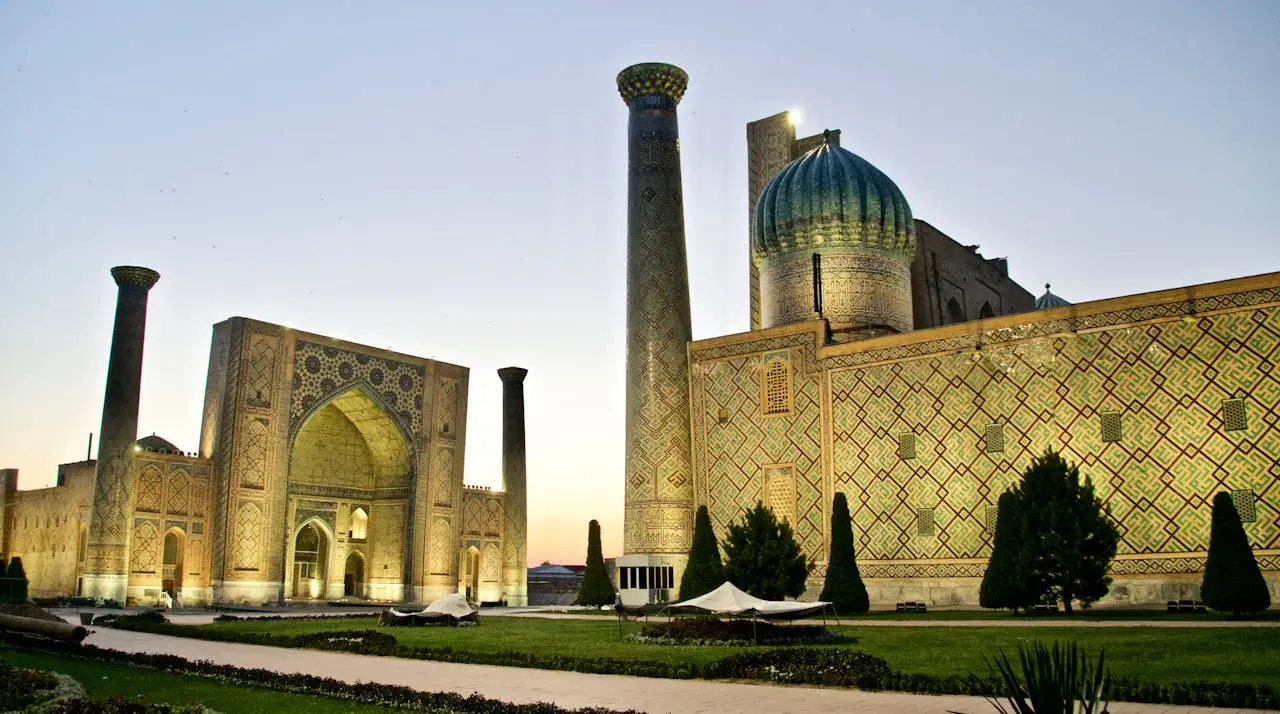 services-02 Capture of the illuminated Registan complex in Samarkand during twilight, highlighting its intricate architecture.