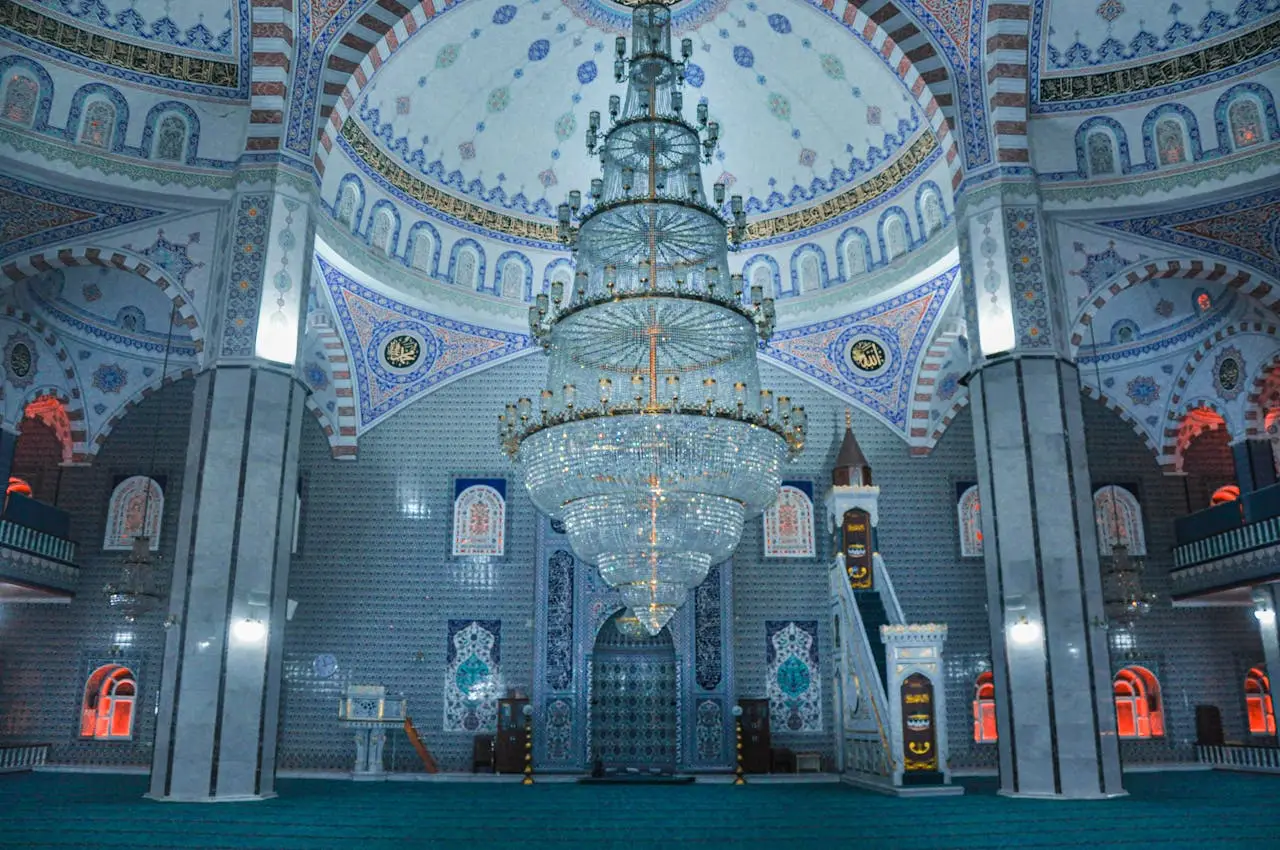 gallery-4 Elegant mosque interior in Turkey with ornate chandelier and detailed mosaics.