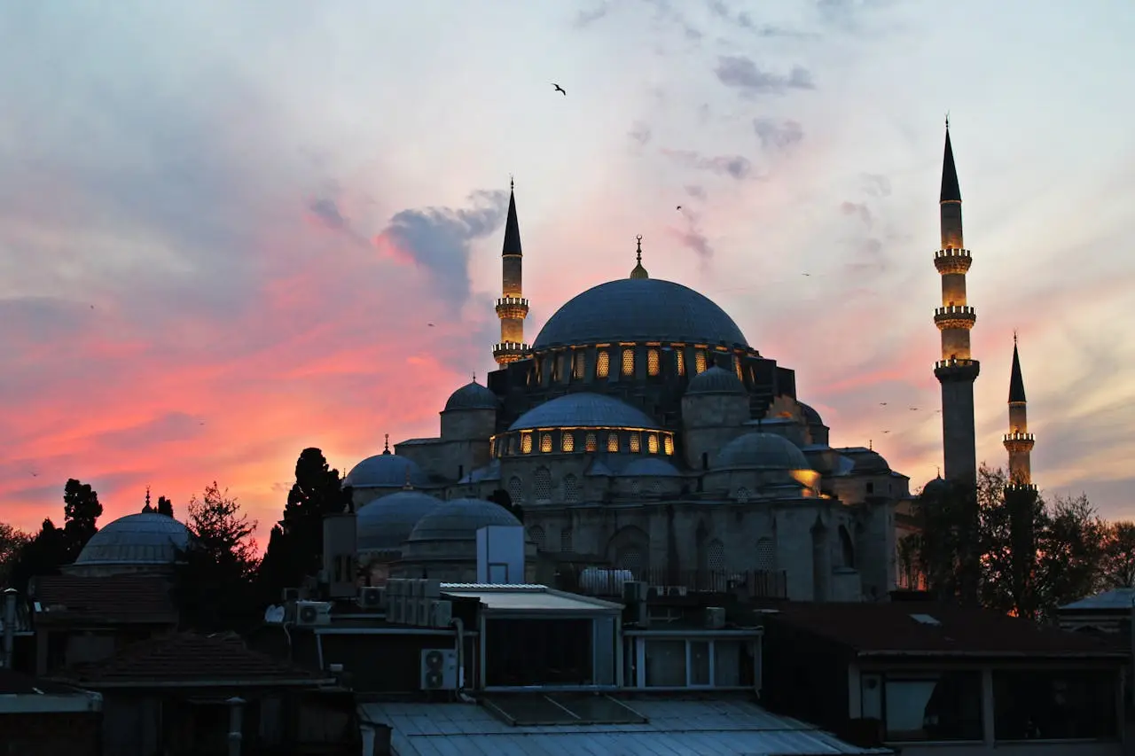 Stunning sunset view of Süleymaniye Mosque with dramatic sky in Istanbul, Turkey.